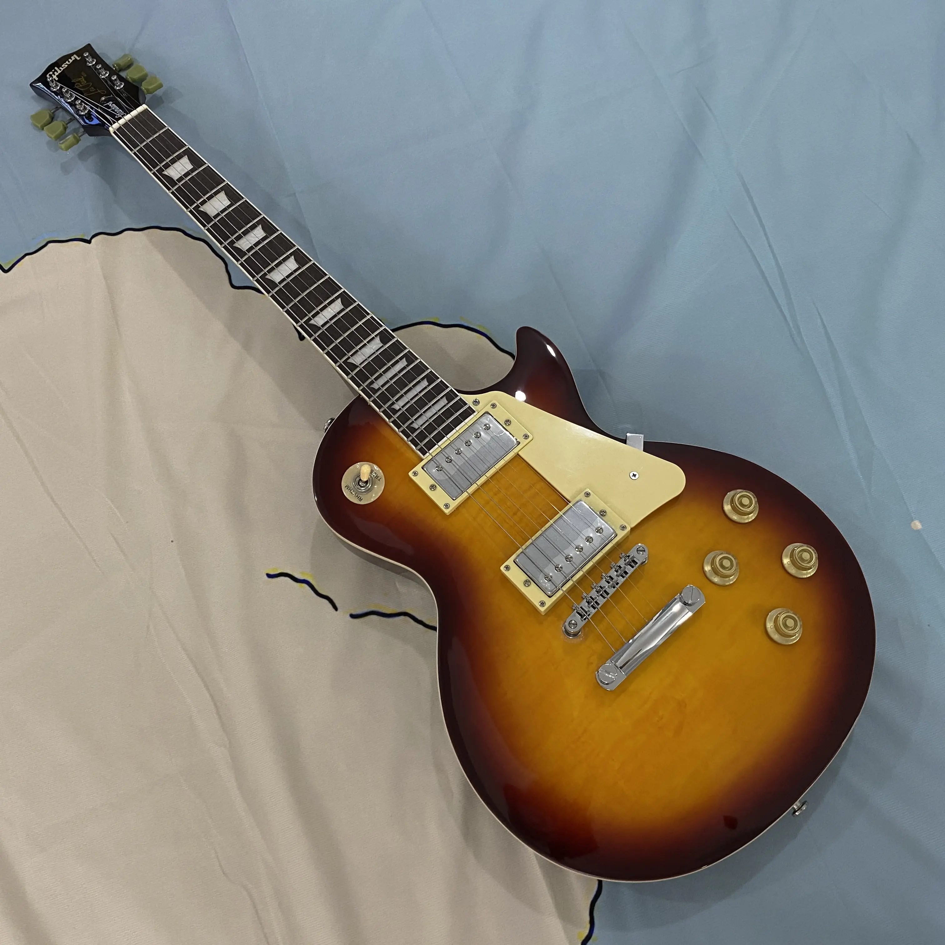 Brown 6-string LP electric guitar with mahogany body, chrome hardware, rosewood fretboard, 22 frets