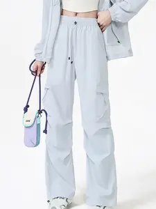 American high-street orange cargo parachute pants made of lightweight quick-dry nylon; drawstring wide-leg pants with multiple pockets and ruched cuffs; unisex streetwear long pants suitable for dancing; ideal for spring/summer outdoor stage outfits.
