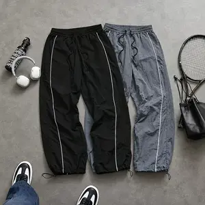 Men’s striped parachute pants with a drawstring waist, tapered design, lightweight summer casual jogging pants, loose athletic pants with an elastic waistband, breathable Y2K street-style long pants with drawstring cuffs—ideal for everyday summer wear.