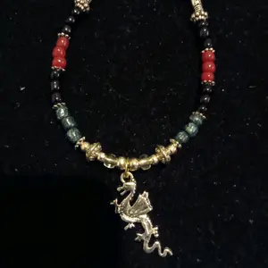 Navajo Handmade silver dragon charm bracelet with red,black, and green beads
