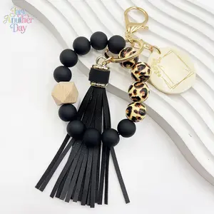Leopard Print Beaded Keychain Wristlet with Black Silicone Beads Wooden Accent and Faux Leather Tassel Stylish Bracelet Keyring for Keys and Bags Trendy Boho Accessory Perfect Gift for Women and Men Lightweight and Durable Easy to Carry