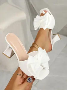 Purple square-toe bow heeled slides with chunky heels, stylish & versatile, perfect for summer dates and commutes, showing sweet elegance.
