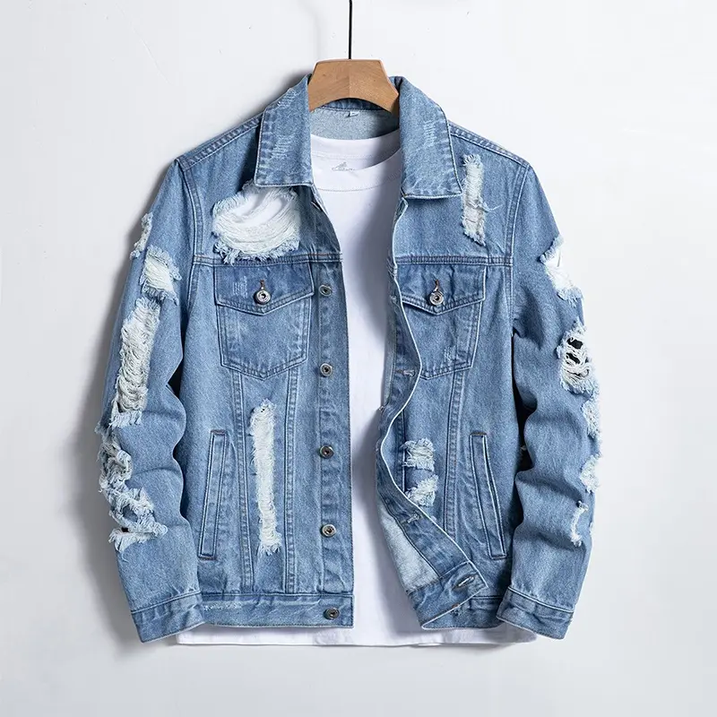 Vintage-style distressed denim jacket featuring rips, frayed edges, and a worn-in finish; a classic workwear-inspired trucker jacket—perfect for streetwear.