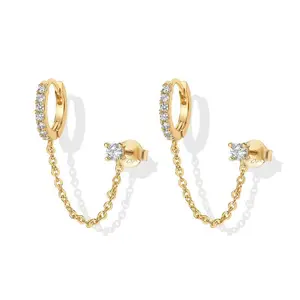 14K Gold Women's Double Piercing Chain Earrings with Dangling Design. The hoop earrings are in a hugging style, and there is a single stud ear cuff set with cubic zirconia.