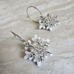 Handmade Polymerclay Earrings with Gilterry White Snowflake and a snowflake Charm on Stainless Steel Hoops for Festive Wear