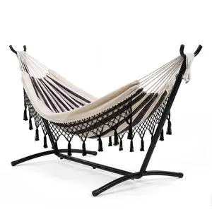 Double Hammock with 9-Foot Stand 2-person boho-style hammock decorated with tassels, supporting up to 450 lbs. Sturdy 9-foot stand ensures stable placement, perfect for indoor and outdoor use. Ideal relaxing bed for backyards, patios, gardens and beaches.