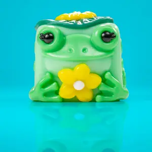 Lily the Frog - Adorable Teal Flower Gardener with Yellow Petals & Green Cabin Design - Inspired by Nature & Peaceful Forest Vibes Taba Squishy