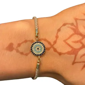 Evil Eye Adjustable Bracelet with Tan Cord and Blue Bead, Stainless Steel Construction, Unique Design Elements