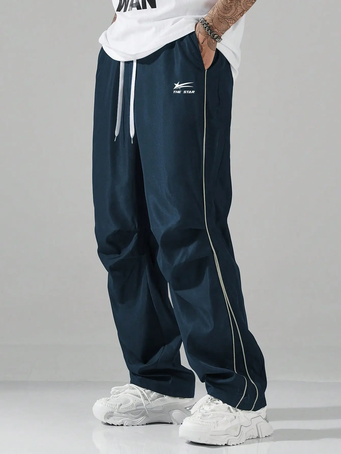 Unisex textured wide leg pants with vertical stripes and a drawstring – crinkled, breathable bubble fabric, elastic drawstring waist, side pockets, relaxed straight fit, American cityboy relaxed style, full length trousers for summer commuting and streetw