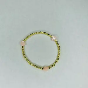 The Blush Bracelet - 6.5” stretchy bracelet Made with: 3mm round gold plated hematite beads with 8mm white color mother of pearl clover beads