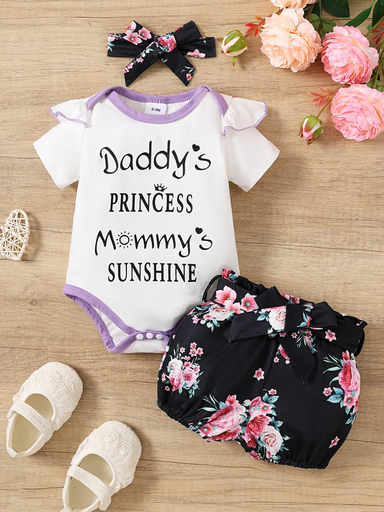 Baby girl's summer white short sleeved jumpsuit with "Daddy's PRINCESS Mommy's SUNSHINE" lettering, purple trimmed ruffle edge sleeves paired with black printed shorts baby clothes