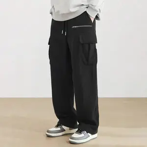 Black corduroy pants with a vintage workwear style, casual and versatile. Made from soft corduroy fabric, featuring an adjustable drawstring waistband, side zipper pockets, and multiple utility pockets.