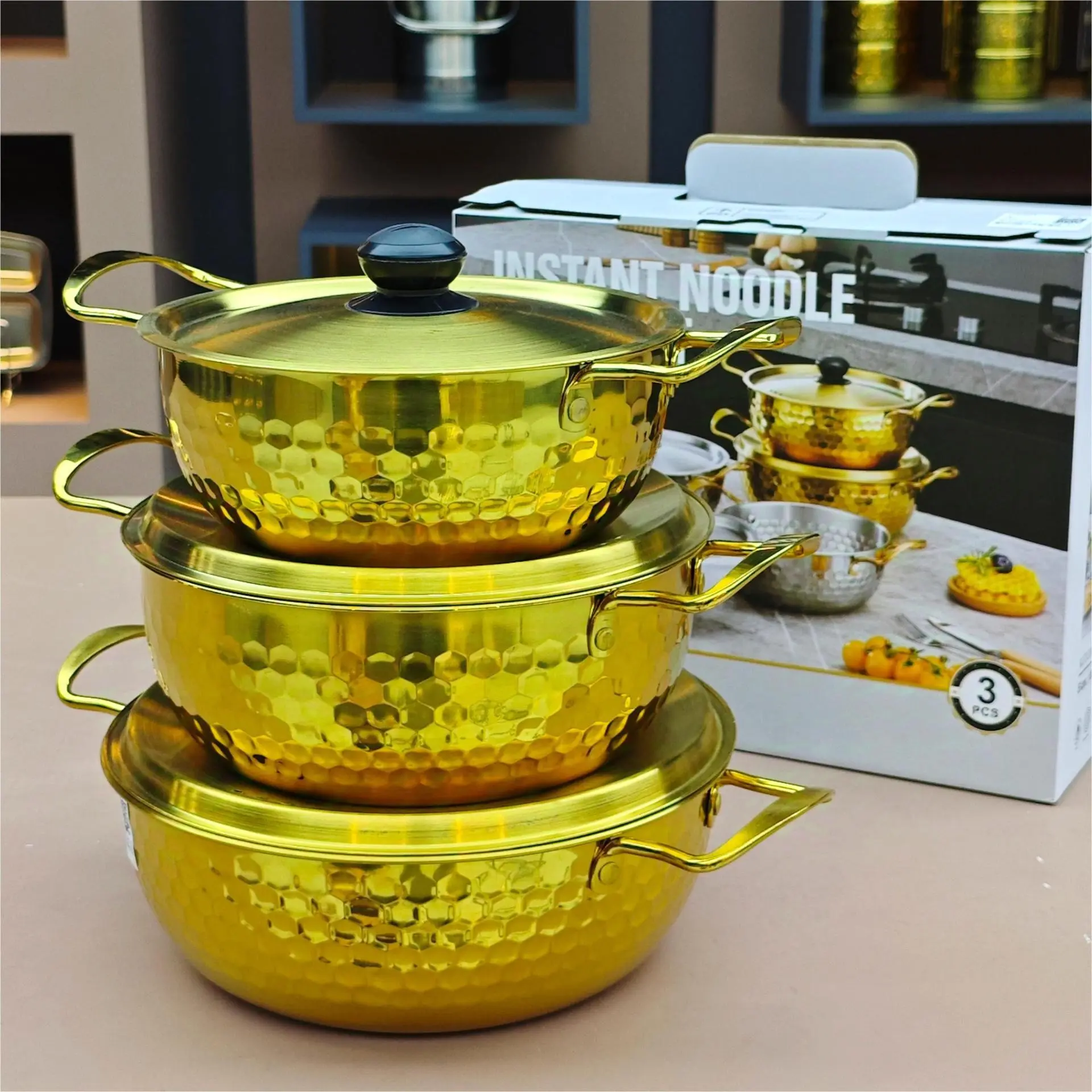 Gold stainless steel noodle pot with lid. Durable non-stick, dishwasher safe, textured base for even heating. Ideal for home, camping, parties, restaurant. Elegant gold finish, modern kitchen essential