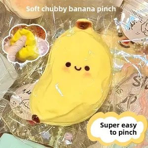 Banana stress-relief toy |   Yellow and pink, smiley face design, ultra-soft TPR material