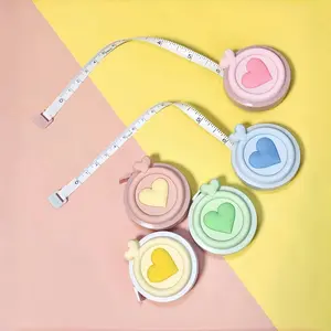 Creative heart-shaped double-sided scale Macaron mini tape measure - portable and multifunctional expandable tape measure for measuring height and body measurements.