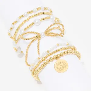 Marleylilly Monogrammed Pearl Bow Bracelet Stack - 7 Separate Brass & Acrylic Bead Bracelets with Personalized Monogram Disc