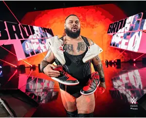 Bronson Reed WWE Unsigned Entrance Sneakers Around His Neck Photograph