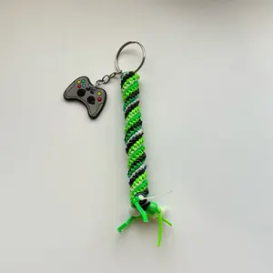 Power Up Rexlace Keychain with Green, White and Black Braided Design and Video Game Controller Charm
