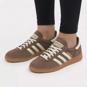 Adidas Handball Spezial Earth Strata Gum Women's | women sneakers | earth tone | handball silhouette | gum sole | stripe | women athletic | lifestyle | retro court | casual | Comfortable Sneakers | Trending Shoes 2026 | Fashion Sneakers | Everyday Shoes
