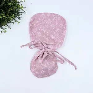 Pink and white Ponytail scrub cap for women with satin lined option by Paradise Caps.