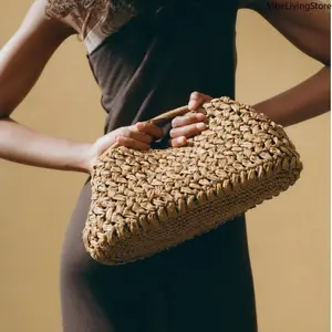 Handmade knitted clutch bag made of natural raffia fiber. Lightweight and stylish in brown color. Ideal for beach, vacation and daily use to store small personal items.