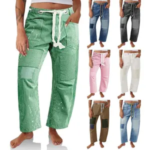 Women’s loose-fit round-cut bucket jeans with horseshoe detailing, wide-leg patch appliqués, a low-rise waist, and pockets—ideal for streetwear. Basic pants for bottoms, suitable for fashionable women's clothing GARMENTARY