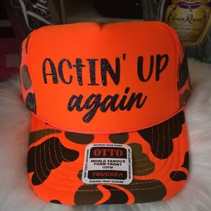 Otto Brand ACTIN' UP AGAIN TRUCKER HAT with Black Glitter Writing Orange Camo Design Premium Foam Fabric