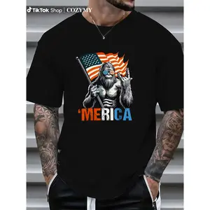 T - Shirt with a Fun Twist: Iconic Bigfoot Figure Holding Flag and Making Hand Gesture with 'Merica' for a Light - hearted Patriotic Vibe