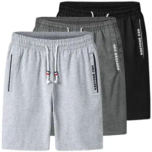 Men’s summer casual athletic shorts in gray, loose straight-leg design with an elastic waistband and drawstring; side zip pockets and lettered woven tape trim along the inseam. Comfortable and breathable, suitable for everyday wear at home or for sports.,