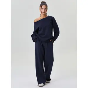 Women’s solid-color leisure co-ord set featuring a long-sleeve top with slanted shoulders and wide-leg trousers; cozy loose two-piece outfit with a scoop neckline; basic women’s wear