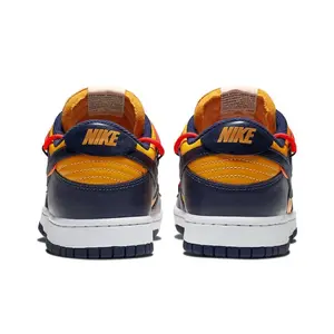 Bold Navy & Orange Low-Top Sneakers with Premium Leather Upper, Featuring a Bright Red Overlay Lacing System, and White Midsole, Perfect for Streetwear Style
