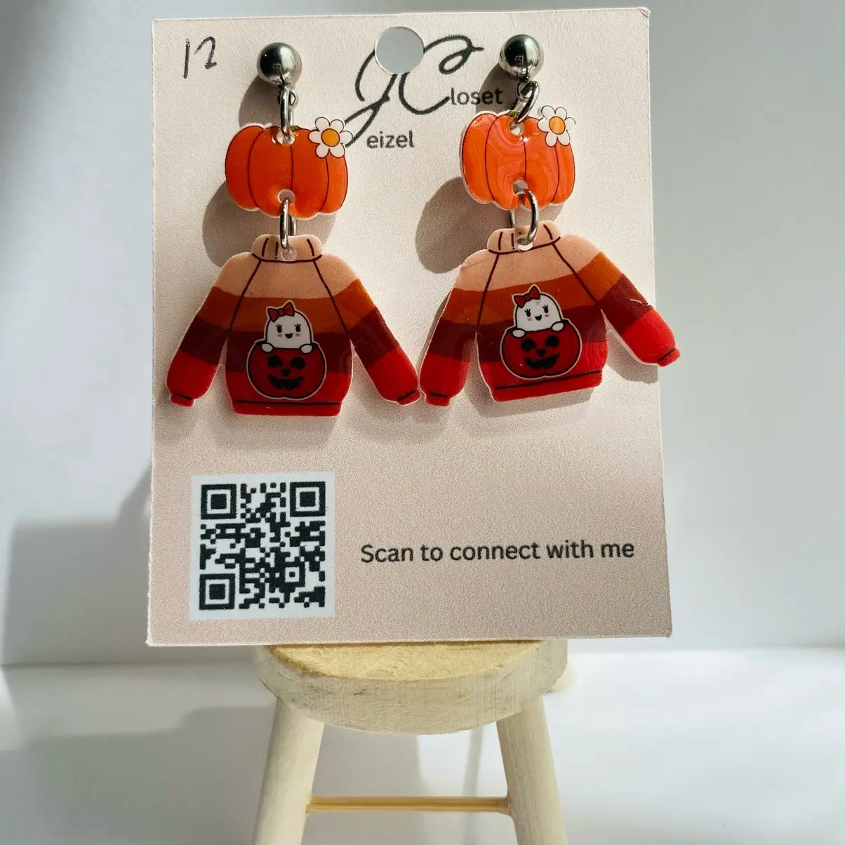 Cute Halloween sweater with pumpkin dangle earring.