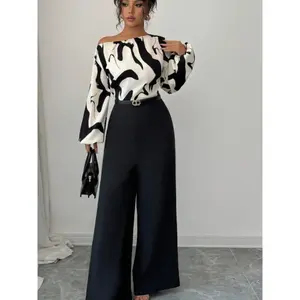 This women’s two-piece set features a geometric-patterned color-blocked off-shoulder blouse with lantern long sleeves, paired with black wide-leg pants. It is suitable for parties, banquets, both indoor and outdoor occasions.