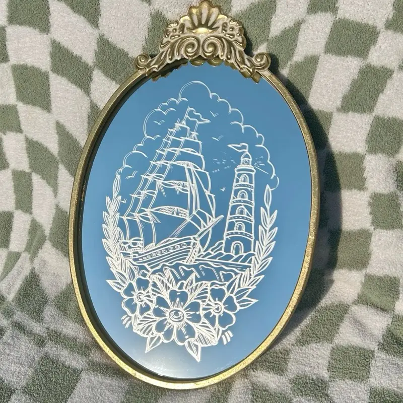 Anchored in Time – Etched Tattoo-Style Sailboat & Lighthouse Mirror | Nautical Wall Decor | Gold Frame | Traditional Flash Art | Ocean Gift