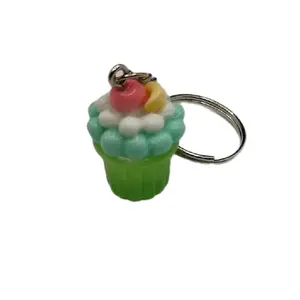 Green Cupcake Keychain - Decorative Keyring with Cupcake Design, Featuring Red and White icing, Ideal for Gifts and Decor