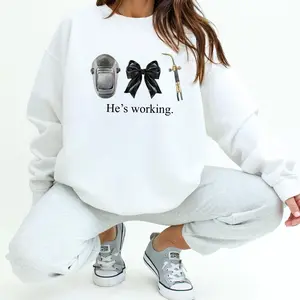 Blue Collar Welder Wife “He’s Working” Sweatshirt – Welding Girlfriend Gift, Trending Christmas Unisex Graphic Sweatshirt, Casual Outfit, Comfortable Menswear & Womenswear Top, Perfect Xmas Gift For Men And Women, Dec8