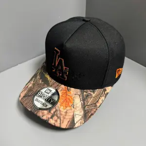 New Era LA Los Angeles Black Snapback - Premium 9FORTY Cap with Hunting Camouflage Pattern Brim, Orange Trim Embroidered Logo, Trendy Unisex Street Wear Accessory.