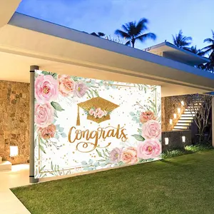 A Pink Graduation Backdrop for The Class of 2026 Featuring a Rose Golden Banner with Floral Designs. This Large Decoration, Measuring , Is Perfect for Both Indoor And Outdoor Graduation Celebrations