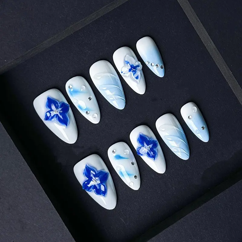 Blue Floral Press On Nails with 3D Flowers and Rhinestones – Icy White and Baby Blue Gradient Almond Nails. Artificial reusable trendy art.