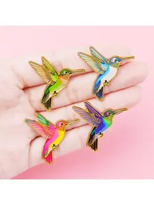 4pcs/set Hummingbird enamel brooch, featuring detailed wing and long beak design; a stylish lapel pin perfect for bird lovers and a fashionable accessory gift.