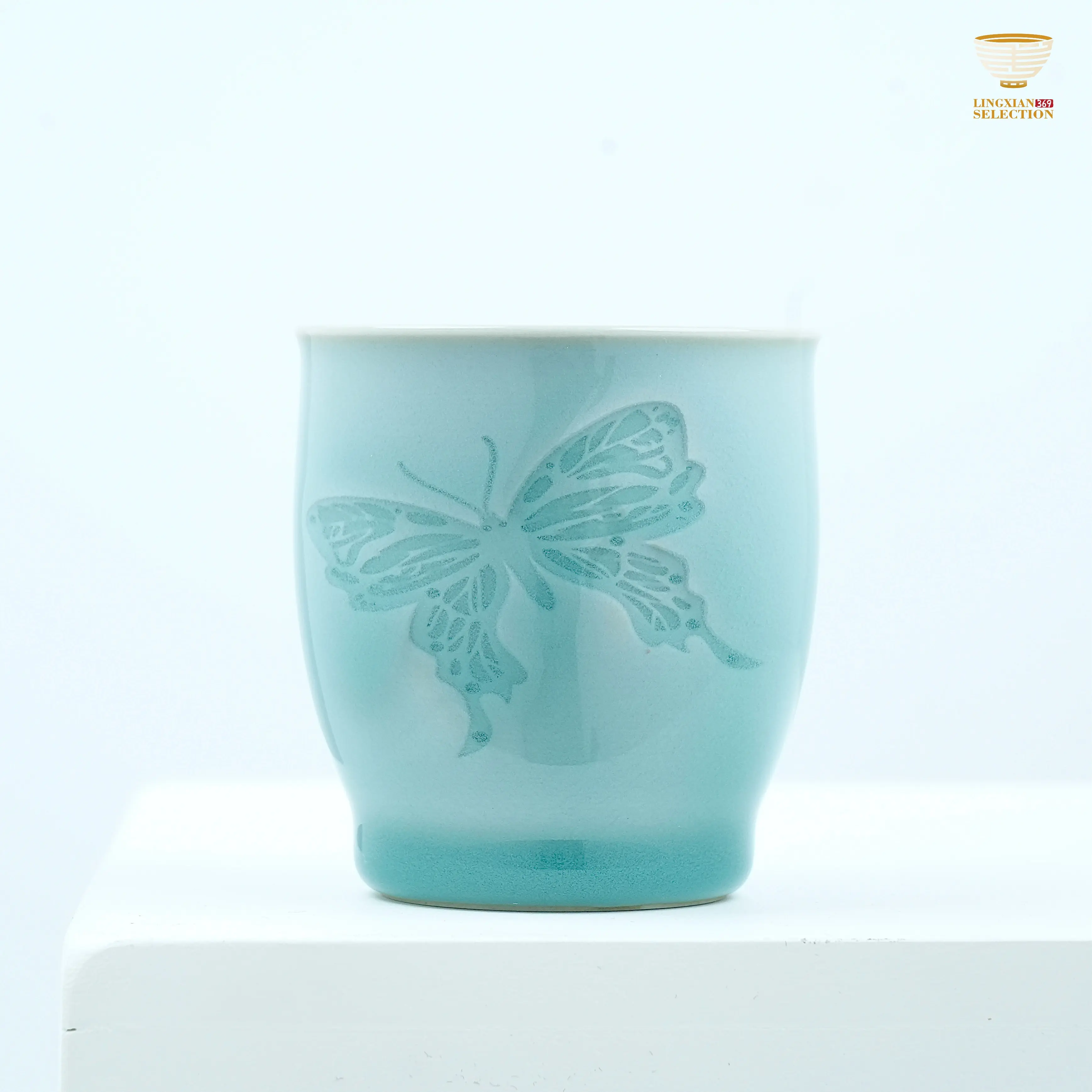Light-Reactive Celadon Tea Cup with Carved Butterfly – Handmade Glowing Porcelain Art by Master LeiHuixian For Ceramic Art Collectors