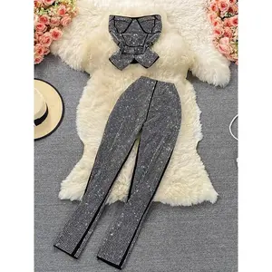 Sexy women’s two-piece set featuring black/white diamond patterns: a party camisole with a slash neckline and off-shoulder design paired with high-waisted pants. A new autumn womenswear piece that can also be worn with a raincoat.