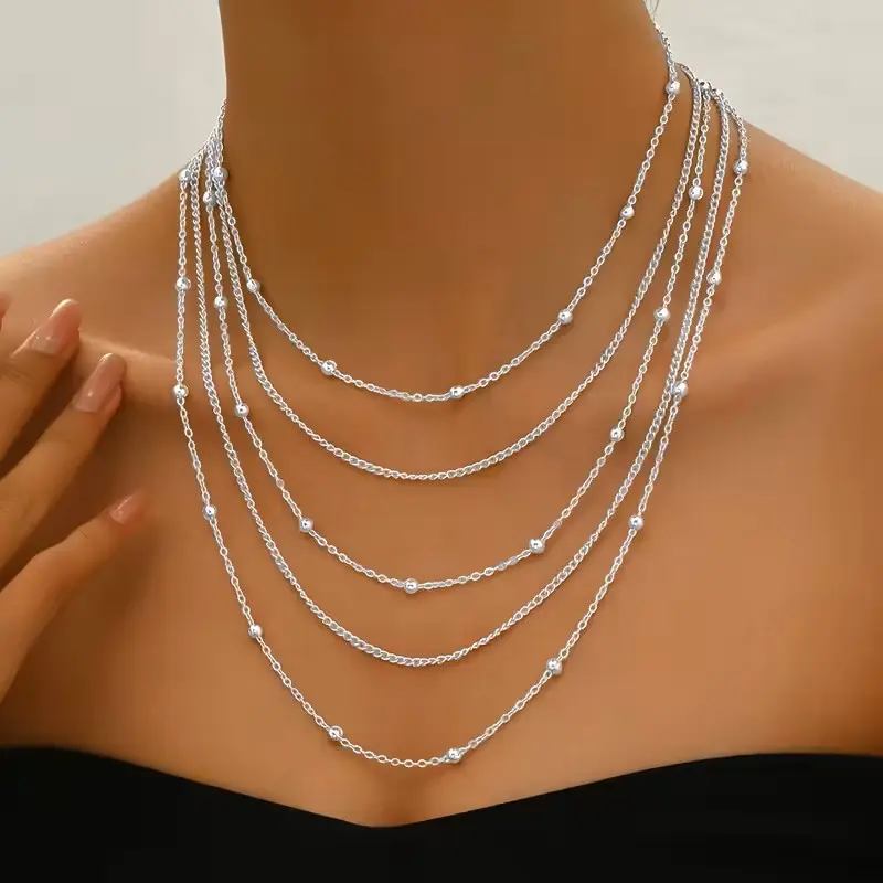 Layered multi strand chain necklace featuring delicate beaded details and an adjustable fit. Lightweight, trendy, and perfect for everyday wear or dressing up. Great for stacking, gifting, parties, weddings, vacations and effortless boho, minimalist style