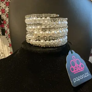 Paparazzi coil bracelet. Very beautiful! Fits all wrist sizes since it’s a coil! Pearl and rhinestones