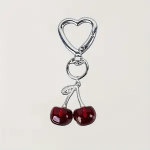 A stylish cherry shaped resin keychain phone pendant with cute metal accessories, Trendy Cute Keychain, Cute Keychain Accessory, making it an ideal gift for loved ones.