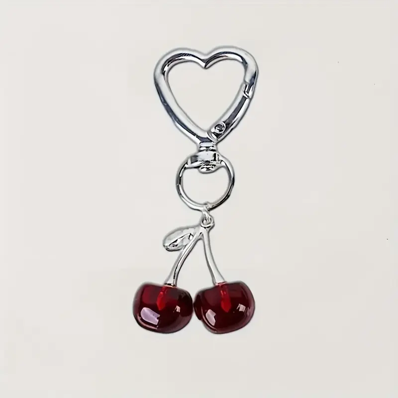 A stylish cherry shaped resin keychain phone pendant with cute metal accessories, Trendy Cute Aesthetic Keychain, Cute Keychain Accessory, making it an ideal gift for loved ones.