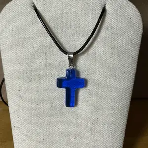 Blue cross pendant on black leather necklace