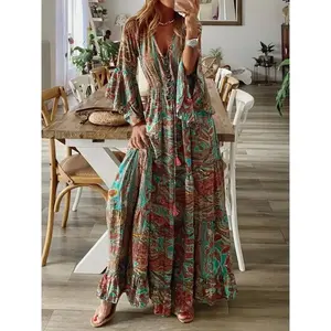 Boho-style long dress with bell sleeves, a V-neck print, high waist for a slimming effect, flowy details; sweet floral A-line dress—ideal for beach vacations and travel photos; WomenGARMENTARY