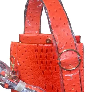 Burnt Orange Purse with Textured Design, Adjustable Strap, and Clasp Closure