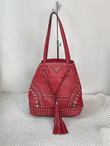 Pre-owned PRADA Red Leather Studded Bucket Bag with Drawstring Closure & Tassel Authentic Gaufre Tote with Braided Handles & Detachable Strap